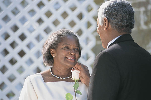 Older wedding couple looking at each other