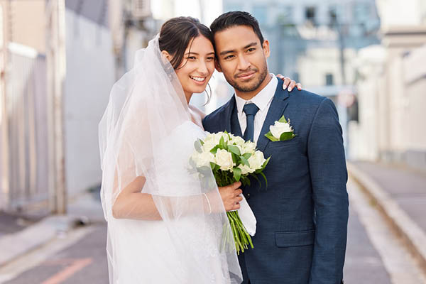 Wedding couple smiling in the road
