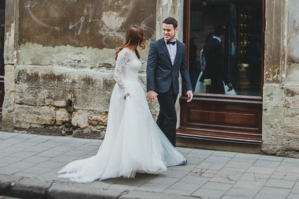 Wedding couple walking down ancient street