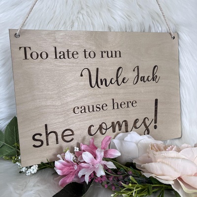 A wooden sign carved with &quot;too late to run Uncle Jack, here she comes!&quot;