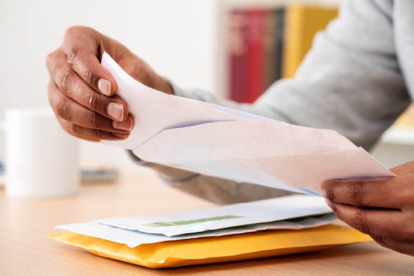 Man opening letter out of envelope