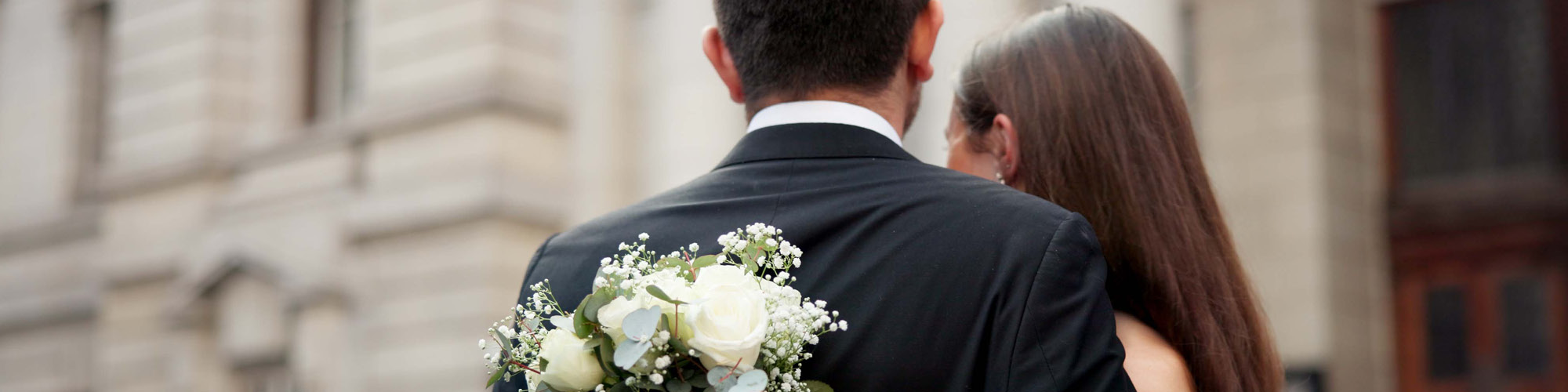 Married couple with flowers and back to camera
