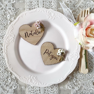 Wooden hearts carved with names on a plate