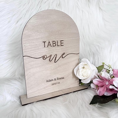 A wooden sign with "Table One" carved onto it.