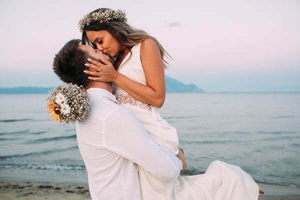 Wedding couple in white on beach