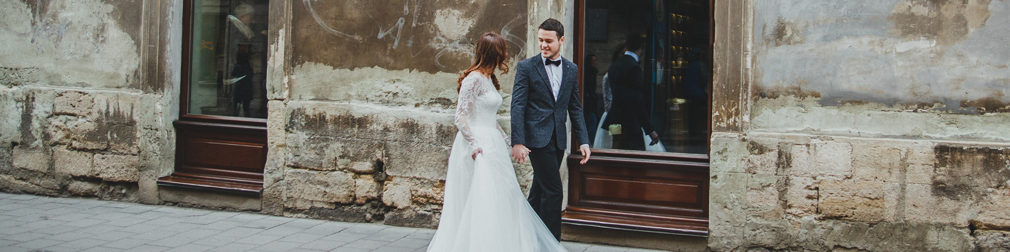 Wedding couple walking through ancient town street